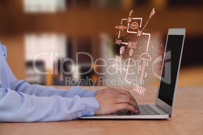 Composite image of cropped image of businesswoman using laptop