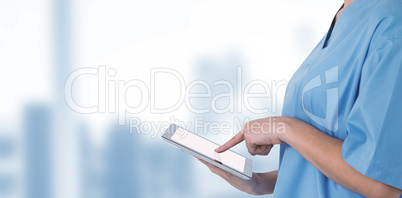 Composite image of midsection of female doctor using digital tablet