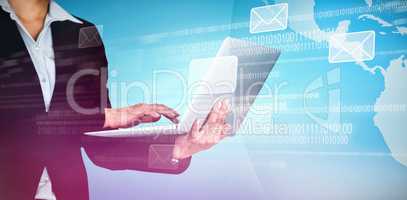 Composite image of businesswoman typing on laptop against blue background