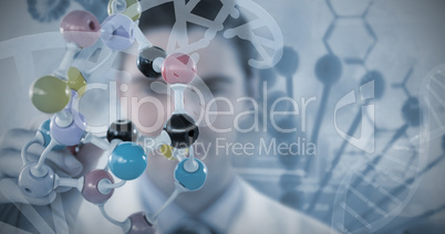 Composite image of scientist holding multi colored molecule structure
