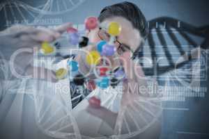 Composite image of scientist holding colorful molecule structure