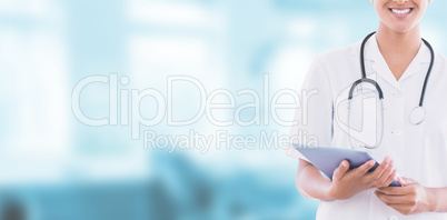 Composite image of happy doctor holding clipboard