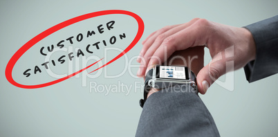 Composite image of businessman checking smart watch