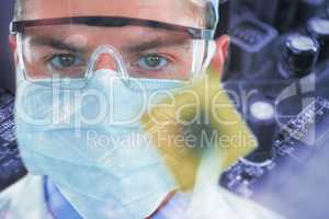 Composite image of doctor in protective glasses and surgical mask holding electronic chip