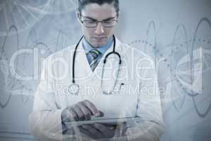 Composite image of young doctor using digital tablet