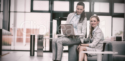 Businesswomen sitting with laptop