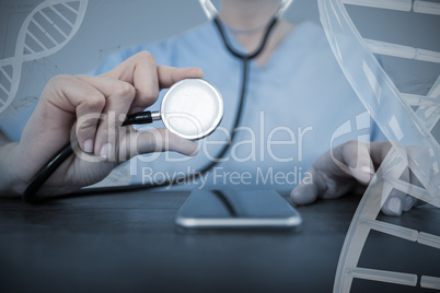 Composite image of midsection of female doctor examining mobile phone with stethoscope