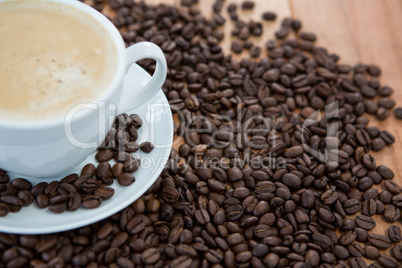 Cup of coffee with roasted coffee beans