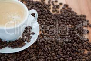 Cup of coffee with roasted coffee beans