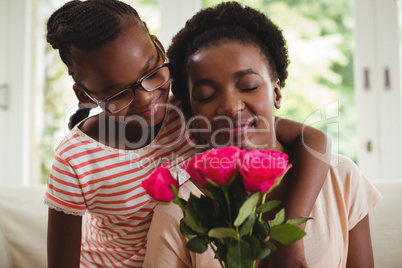 Daughter with arms around mother shoulders