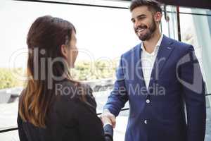 Business executives shaking hands on platform