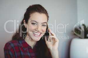 Female executive talking on mobile phone in office