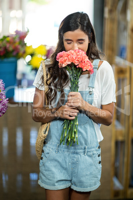 Woman smelling a bunch of flowers