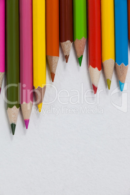 Close-up of colored pencils arranged in a wave pattern