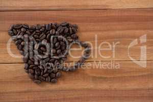 Coffee beans forming shape of cup