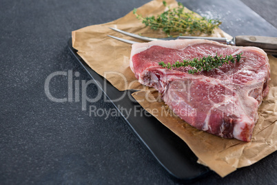 Sirloin chop and fork on slate plate