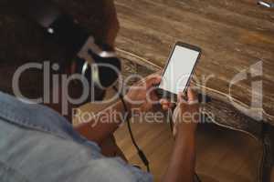 Man listening to music on mobile phone in living room