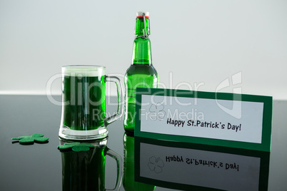 Green beer with shamrock and placard of St Patricks Day