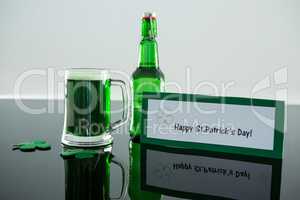 Green beer with shamrock and placard of St Patricks Day
