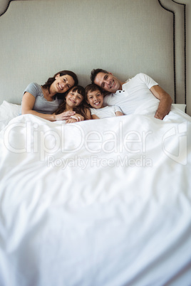 Parents and kids sitting on the bed