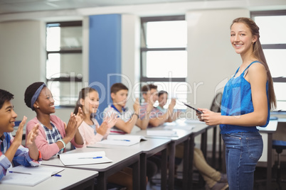 Students appreciating classmate after presentation in classroom