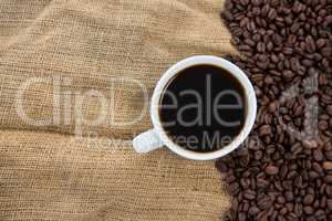 Black coffee and coffee beans on sack