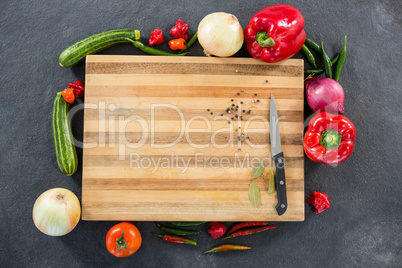 Vegetables around wooden board