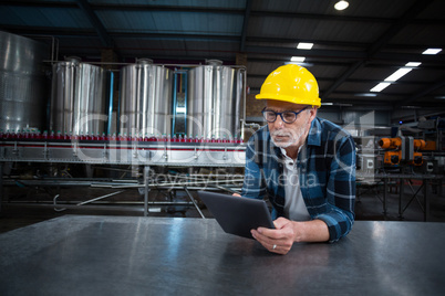 Factory worker using digital tablet