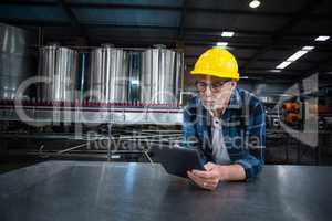 Factory worker using digital tablet