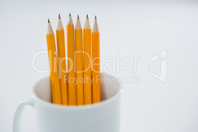 Yellow color pencils kept in mug