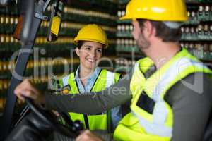 Factory workers interacting with each other in factory