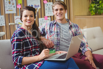 Portrait of executives doing online shopping on laptop