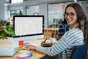 Female graphic designer working at desk