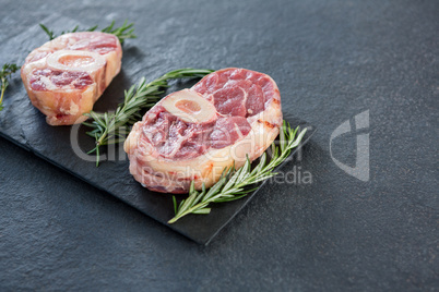 Sirloin chops and rosemary herb on slate plate