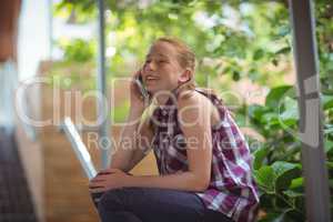 Happy schoolgirl talking on mobile phone