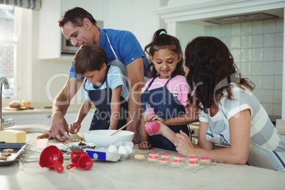 Happy family preparing cookies in kitchen