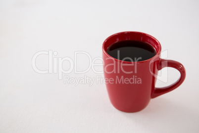 Black coffee served in red cup