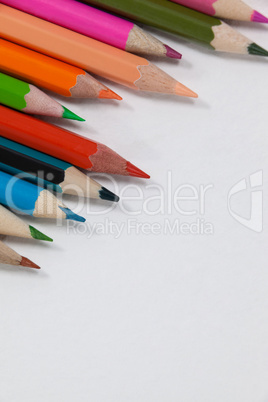 Close-up of colored pencils arranged in a wave pattern