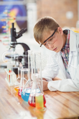 Attentive schoolboy doing a chemical experiment in laboratory