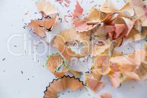 Colored pencils shavings on a white background