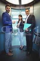 Portrait of business executives standing in lift