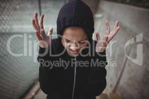 Angry teenage girl standing at school campus