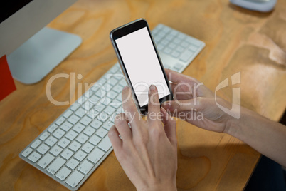 Hand of female graphic designer using mobile phone