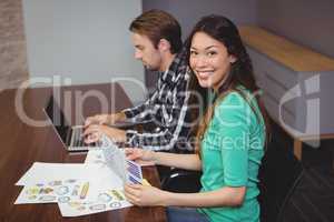 Male and graphic designers working together in conference room