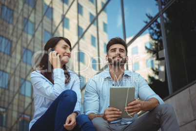 Executives listening music on digital tablet