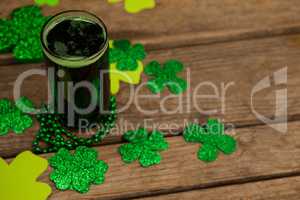 Glass of green beer, beads and shamrock for St Patricks Day