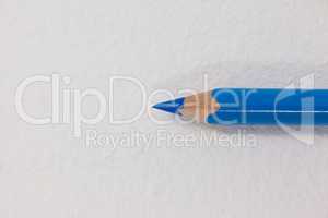 Blue colored pencil on white background