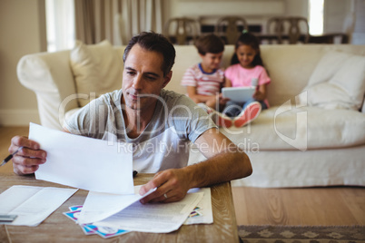 Man holding a bill in living room