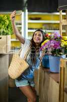 Woman taking a selfie at florist shop