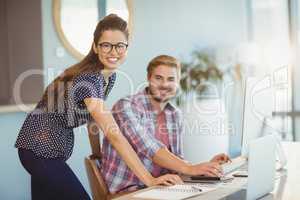 Portrait of graphic designers working on personal computer